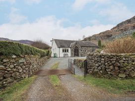 A house with a stone wall and pathway at Thrang View in Chapel Stile