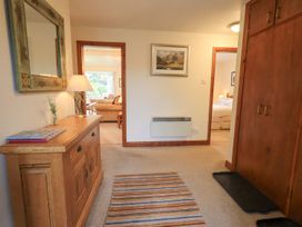 A hallway with a table and lamp at Thrang View in Chapel Stile