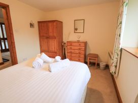 A bedroom with a bed, wardrobe, and chest of drawers at Thrang View in Chapel Stile