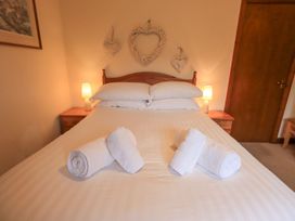 A bedroom with a bed and towels arranged on it at Thrang View in Chapel Stile