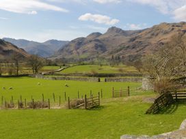 A view of fields and mountains with sheep at Thrang View in Chapel Stile