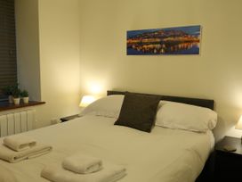A bedroom with a bed and side tables at Rockfish Cottage in Brixham