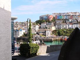 A view of colorful houses and a harbor at Rockfish Cottage in Brixham
