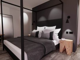 A bedroom with a bed and bedside table at Arvo Suite 1.0 in Marhamchurch