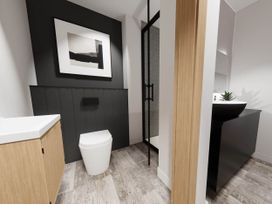 A bathroom with a toilet, sink, and shower at Arvo Suite 1.0 in Marhamchurch