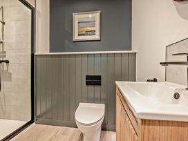 A bathroom with a toilet and sink at Arvor Suite 1.0 in Marhamchurch