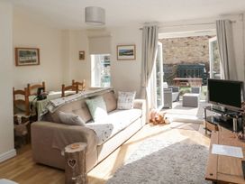 A living room with a sofa and television at Ramblers Cottage in Alnwick