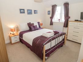 A bedroom with a double bed and bedside tables at Ramblers Cottage in Alnwick