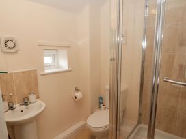 A bathroom featuring a shower, toilet, and sink at Ramblers Cottage in Alnwick