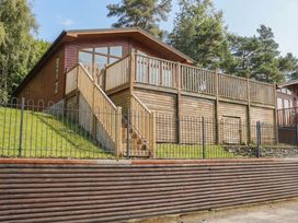 A house with a deck and stairs at High Lake View Lodge White Cross Bay near Troutbeck Bridge