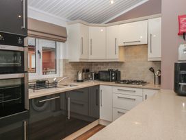 A kitchen with appliances and a sink at High Lake View Lodge White Cross Bay near Troutbeck Bridge
