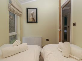 A bedroom with two beds and a picture at High Lake View Lodge in White Cross Bay near Troutbeck Bridge
