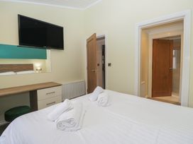 A bedroom with a bed and a television at High Lake View Lodge, White Cross Bay near Troutbeck Bridge