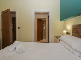 A bedroom with a bed and doors at High Lake View Lodge near White Cross Bay