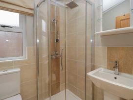 A bathroom with a shower and sink at High Lake View Lodge White Cross Bay near Troutbeck Bridge