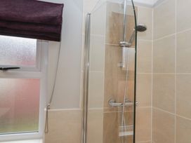 A bathroom showing a shower enclosure and window at High Lake View Lodge in White Cross Bay near Troutbeck Bridge
