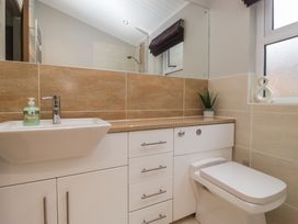 A bathroom with a sink and toilet at High Lake View Lodge White Cross Bay near Troutbeck Bridge