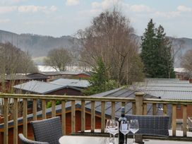 A view of cabins and a lake from a deck at High Lake View Lodge near Troutbeck Bridge