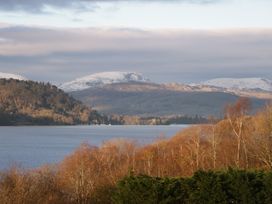 A view of a lake with mountains and trees at High Lake View Lodge White Cross Bay near Troutbeck Bridge