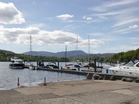 A view of boats docked at a pier with mountains in the background at High Lake View Lodge, White Cross Bay near Troutbeck Bridge