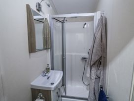 A bathroom with a shower and sink at Lakeside Lodge in Stonham Aspal