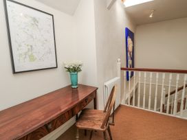 A hallway with a desk and map at Ostlers in Burford