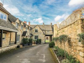 An outdoor area with stone buildings and plants at Ostlers Burford