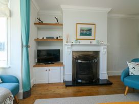 A living room with a fireplace and television at 43 Sandquay Road in Dartmouth
