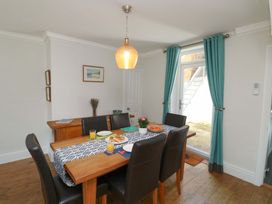 A dining room with a table set for a meal at 43 Sandquay Road Dartmouth