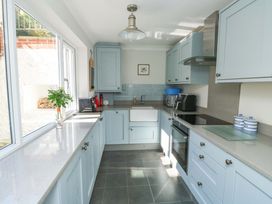 A kitchen with cabinets and appliances at 43 Sandquay Road Dartmouth