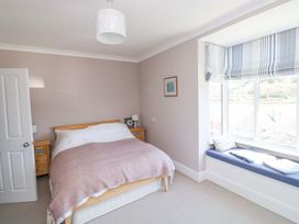 A bedroom with a bed and window seat at 43 Sandquay Road Dartmouth