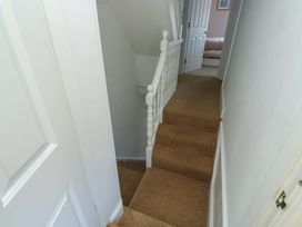 A staircase with a handrail and carpet at 43 Sandquay Road Dartmouth