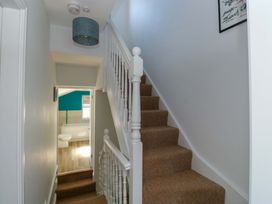 A hallway with staircase and bathroom door at 43 Sandquay Road, Dartmouth