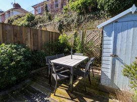 A garden with table and chairs beside a shed at 43 Sandquay Road in Dartmouth