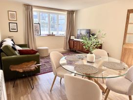A living room featuring a dining table, chairs, and a sofa at Cotswolds Farmhouse Cottage