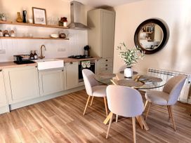 A kitchen with a dining table and chairs at Cotswolds Farmhouse Cottage