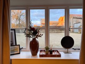 A living room with a window and decor at Cotswolds Farmhouse Cottage