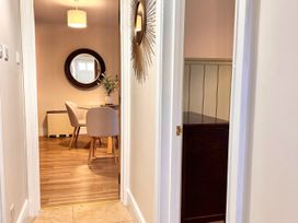 A dining room with a mirror and table at Cotswolds Farmhouse Cottage