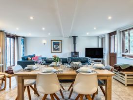 A dining room with a table set for dinner at Woodyplatt in Marhamchurch