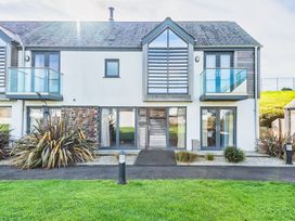 A house with balconies and plants at Chapel Park in Marhamchurch