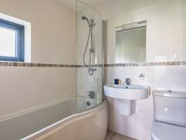 A bathroom with a bathtub, shower, sink, and toilet at Little Main in Marhamchurch