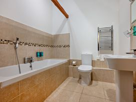 A bathroom with bathtub sink and toilet at Long Down Spa Marhamchurch