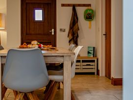 A dining room with a table and chairs at Middle Hill in Marhamchurch