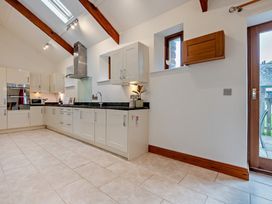 A kitchen with cabinetry and appliances at Middle Hill in Marhamchurch