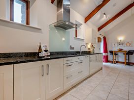A kitchen with cabinets and sink at Middle Hill in Marhamchurch
