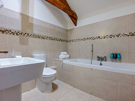 A bathroom with a bathtub, toilet, and sink at Middle Hill in Marhamchurch