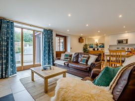 A living room with a sofa and coffee table at Sand Parks in Marhamchurch