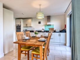 A dining room with a table set for meals at Venners in Marhamchurch