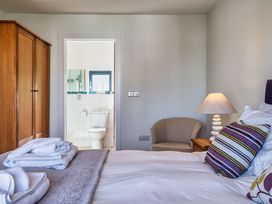 A bedroom with wardrobe and bathroom visible at Venners in Marhamchurch