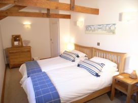 A bedroom with twin beds and wooden furniture at Westcotts in Marhamchurch